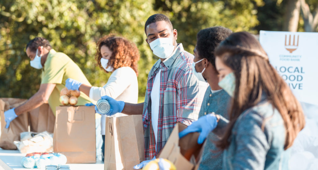 a group of diverse people volunteering at a local food drive