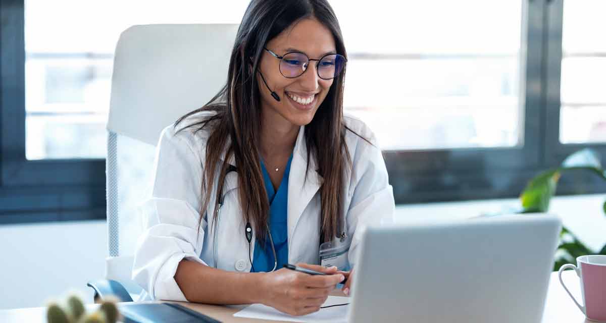 doctor sitting at desk for telehealth appointment