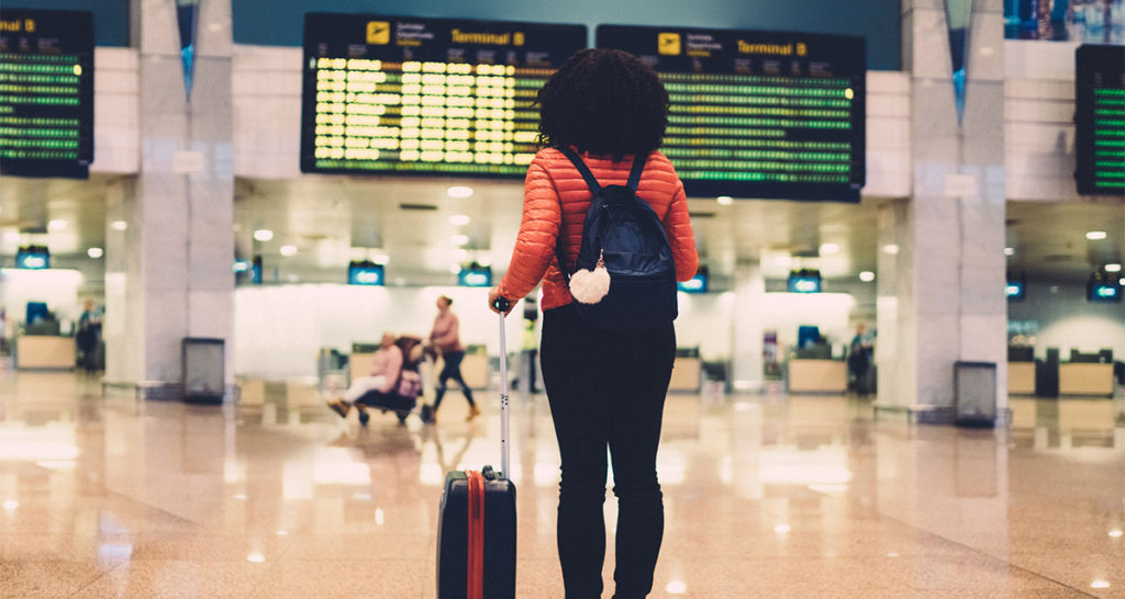 Young woman at the airport ready to travel